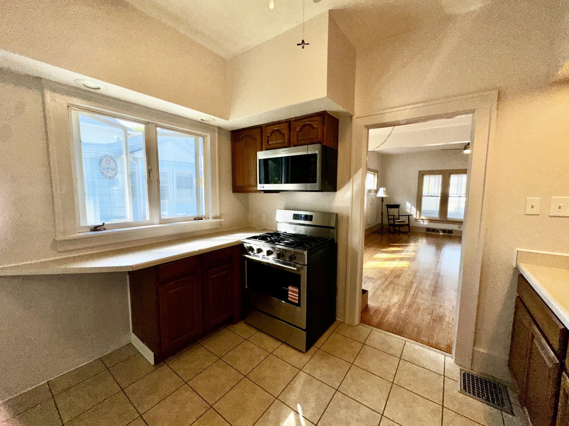 45 North Sunset Avenue Freeport, IL 61032 - Photo 11 of 23 a kitchen with stainless steel appliances granite countertop a stove top oven a sink a counter top space and cabinets