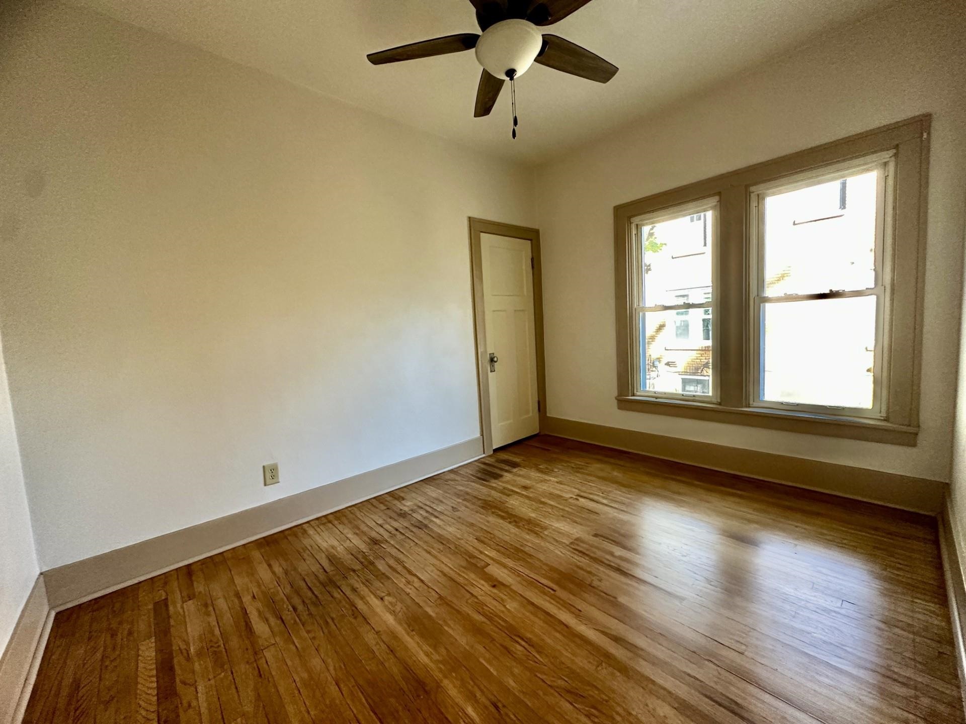 45 North Sunset Avenue Freeport, IL 61032 - Photo 12 of 23 a view of an empty room with wooden floor and a window