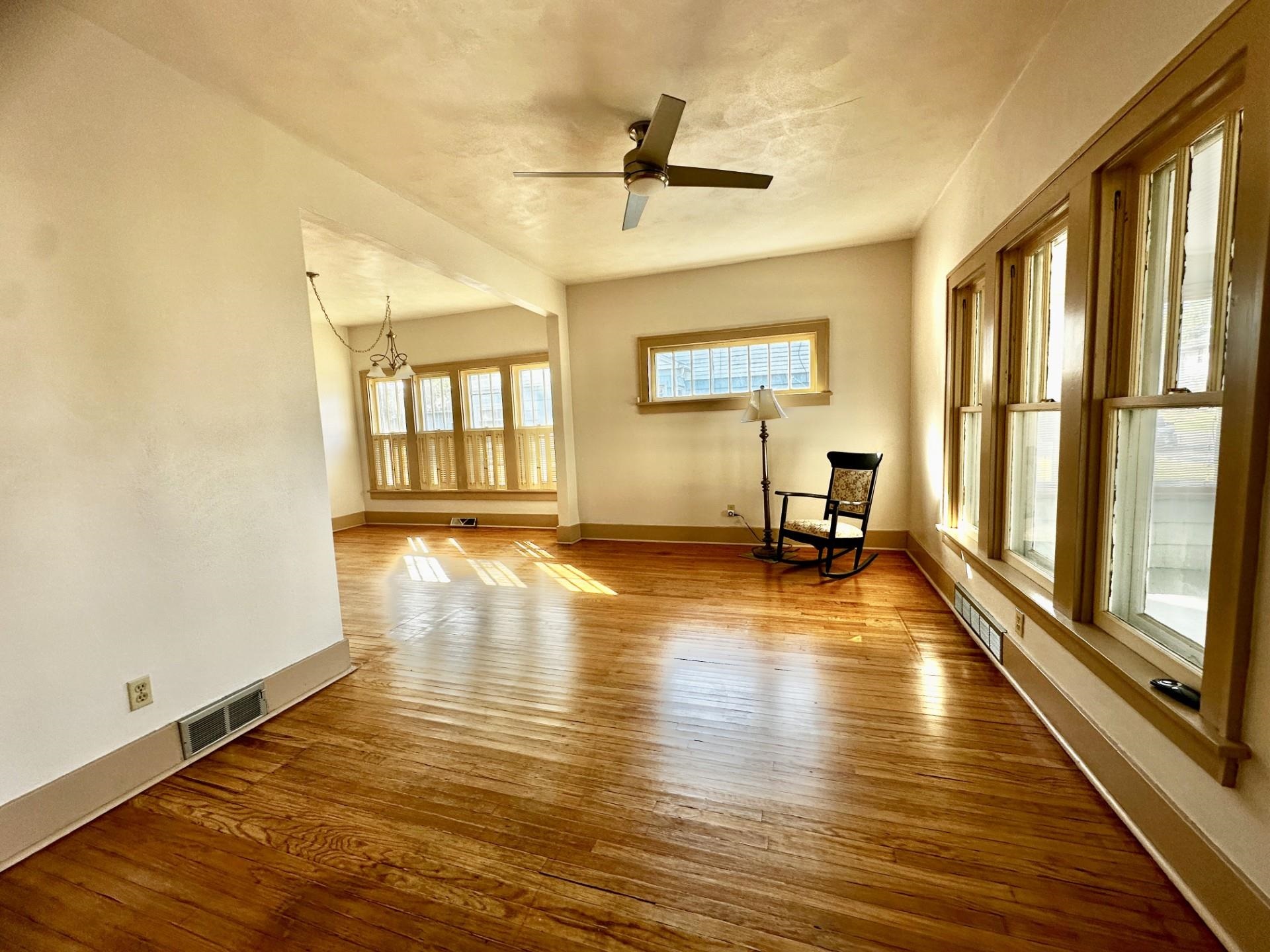 45 North Sunset Avenue Freeport, IL 61032 - Photo 3 of 23 a view of empty room with wooden floor and floor to ceiling window