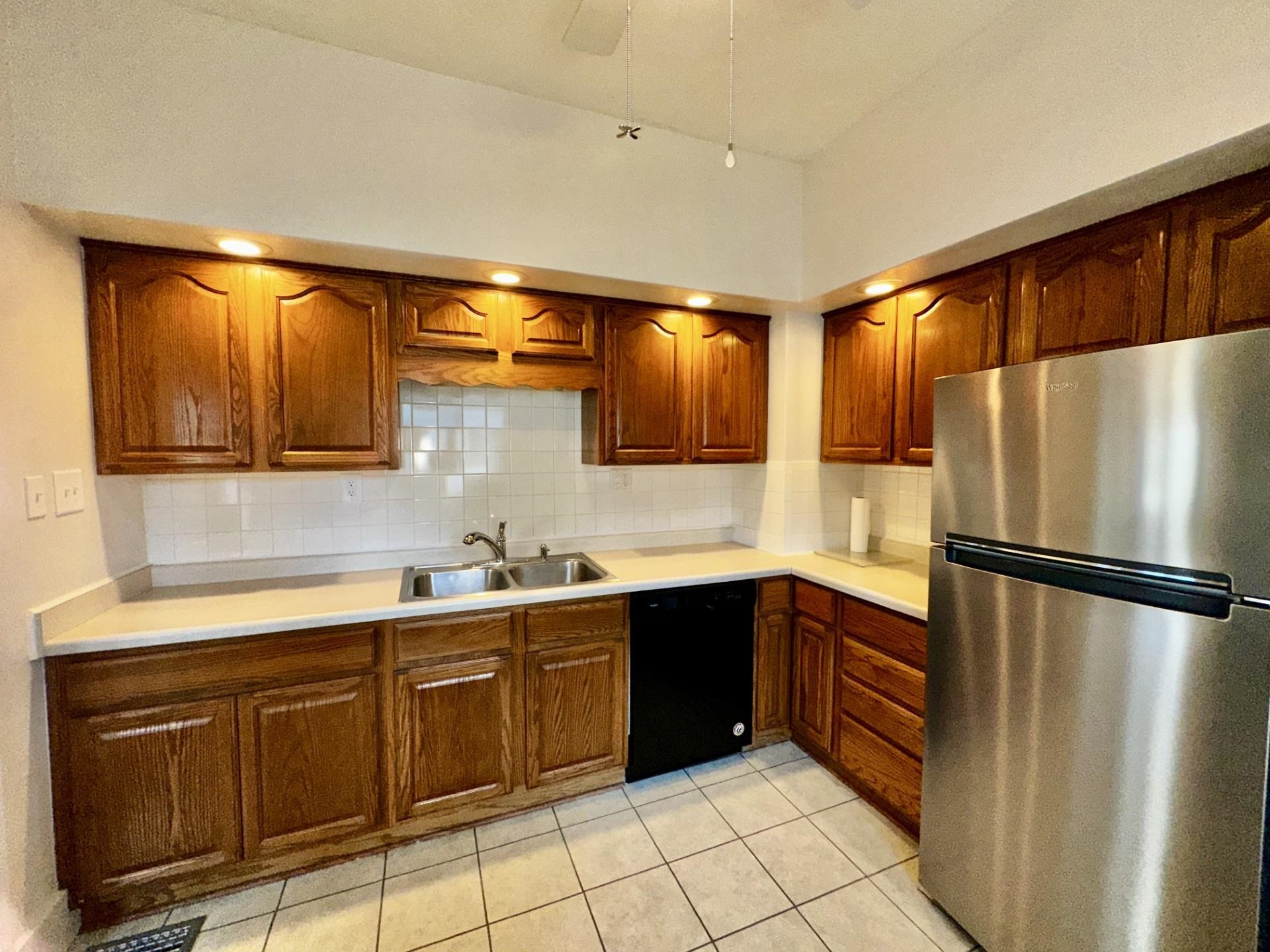 45 North Sunset Avenue Freeport, IL 61032 - Photo 9 of 23 a kitchen with a sink a refrigerator and cabinets