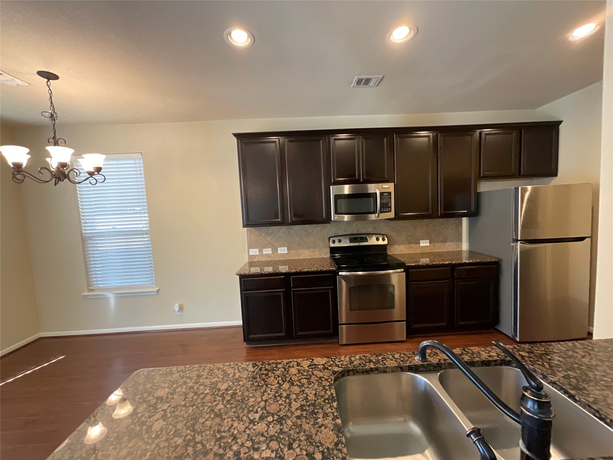 1911 Conn Creek Road Cedar Park, TX 78613 - Photo 14 of 39 a kitchen with granite countertop a refrigerator and a sink