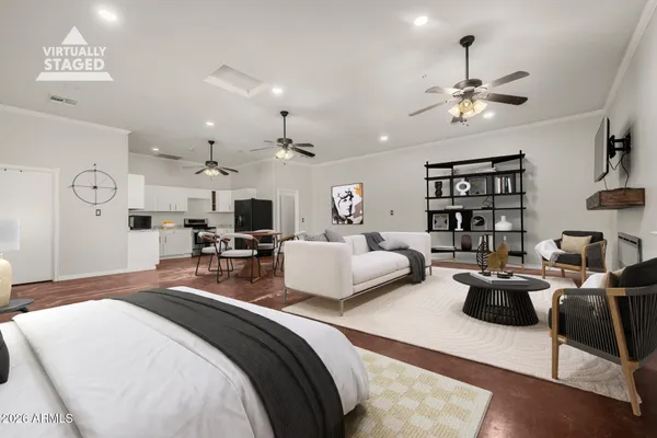 a bedroom with a bed a couch and chandelier