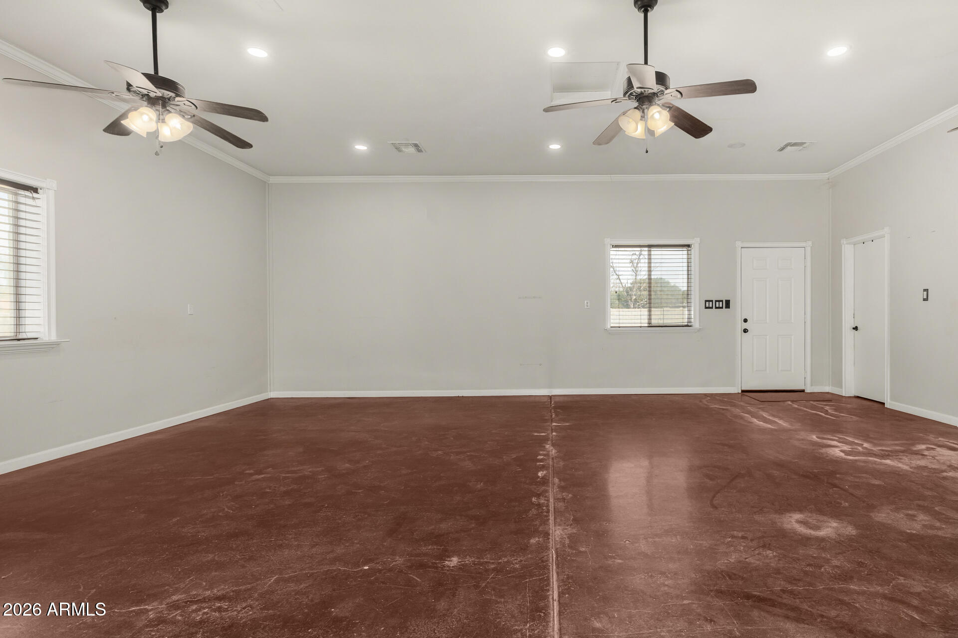 2266 East Willis Road Gilbert, AZ 85297 - Photo 2 of 15 a view of an empty room with a chandelier fan and a window