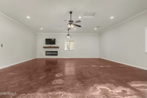 a view of empty room with fireplace and windows