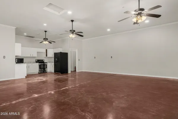 an empty room with a ceiling fan and a window