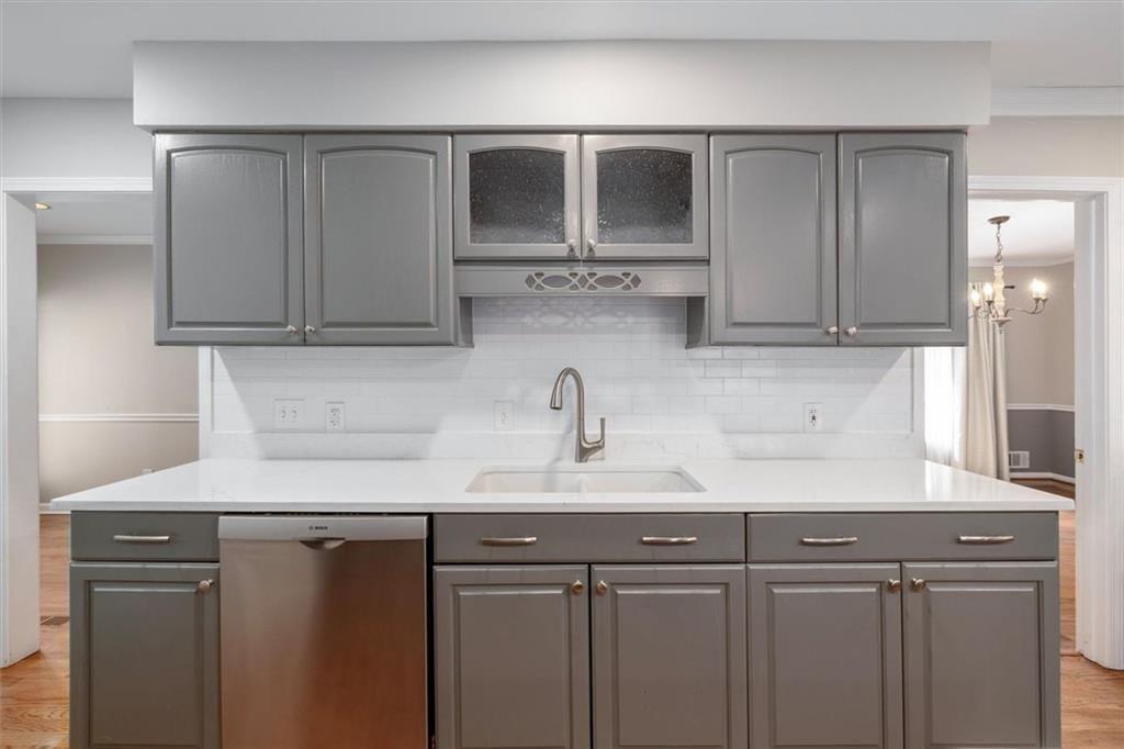 5498 Smoke Rise Drive Smoke Rise, GA 30087 - Photo 12 of 52 a kitchen with stainless steel appliances granite countertop white cabinets and a sink