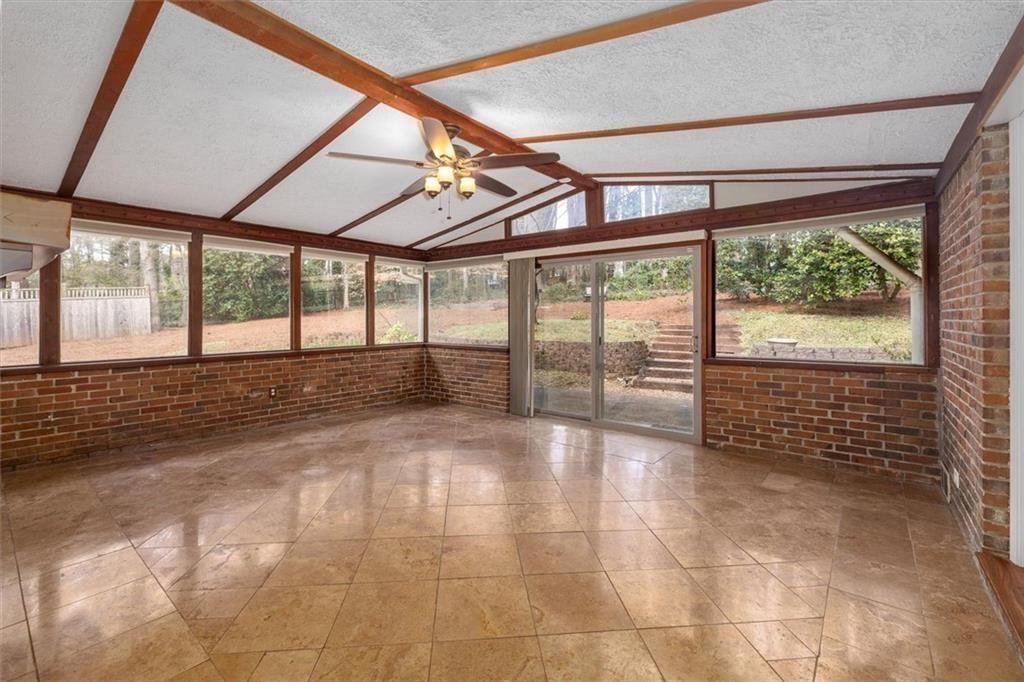 5498 Smoke Rise Drive Smoke Rise, GA 30087 - Photo 13 of 52 a view of an empty room with a floor to ceiling window and an outdoor view