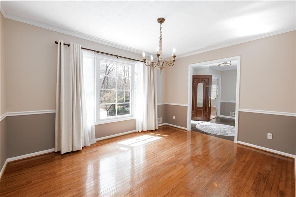 5498 Smoke Rise Drive Smoke Rise, GA 30087 - Photo 15 of 52 a view of an empty room with glass door and wooden floor