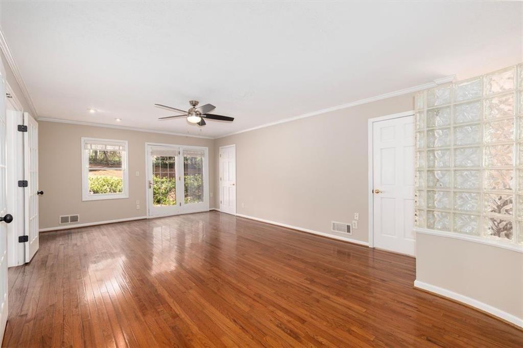 5498 Smoke Rise Drive Smoke Rise, GA 30087 - Photo 17 of 52 an empty room with wooden floor and windows
