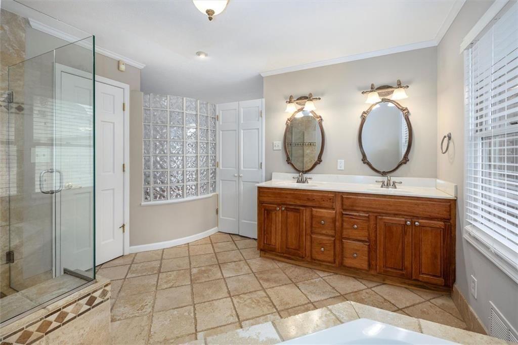 5498 Smoke Rise Drive Smoke Rise, GA 30087 - Photo 20 of 52 a bathroom with a double vanity sink mirror and shower