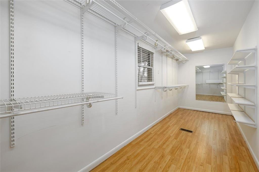 5498 Smoke Rise Drive Smoke Rise, GA 30087 - Photo 21 of 52 a view of a room with wooden floor and white doors