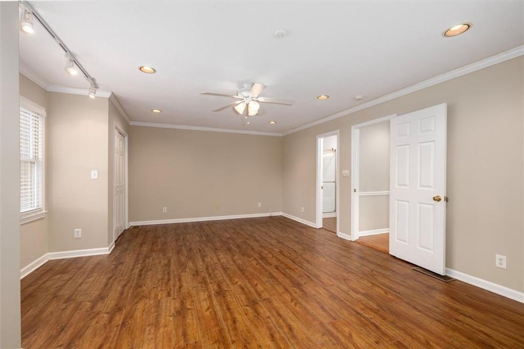 5498 Smoke Rise Drive Smoke Rise, GA 30087 - Photo 25 of 52 a view of empty room with wooden floor and fan