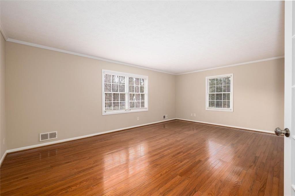 5498 Smoke Rise Drive Smoke Rise, GA 30087 - Photo 28 of 52 an empty room with wooden floor and windows