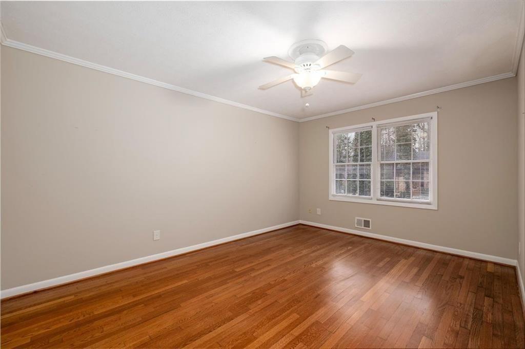 5498 Smoke Rise Drive Smoke Rise, GA 30087 - Photo 30 of 52 a view of an empty room with wooden floor and a window