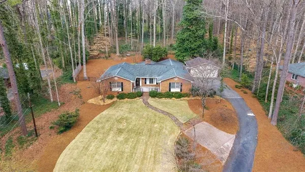 a aerial view of a house with swimming pool and garden