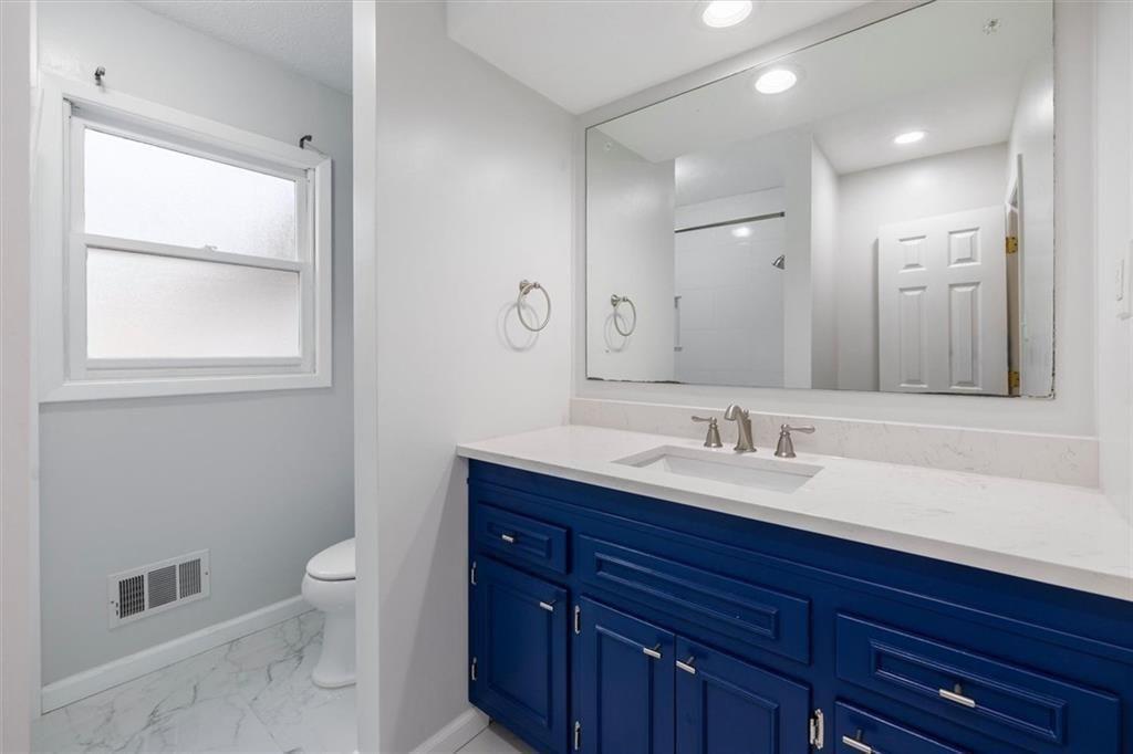 5498 Smoke Rise Drive Smoke Rise, GA 30087 - Photo 32 of 52 a bathroom with a toilet a sink and mirror