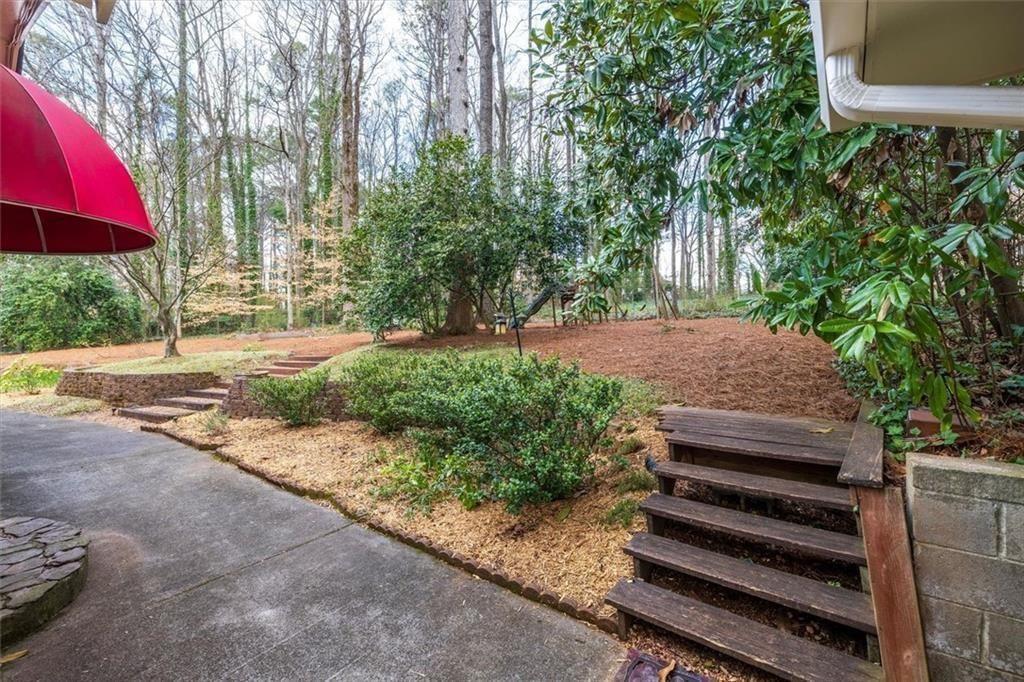 5498 Smoke Rise Drive Smoke Rise, GA 30087 - Photo 37 of 52 a view of a park with plants and a bench
