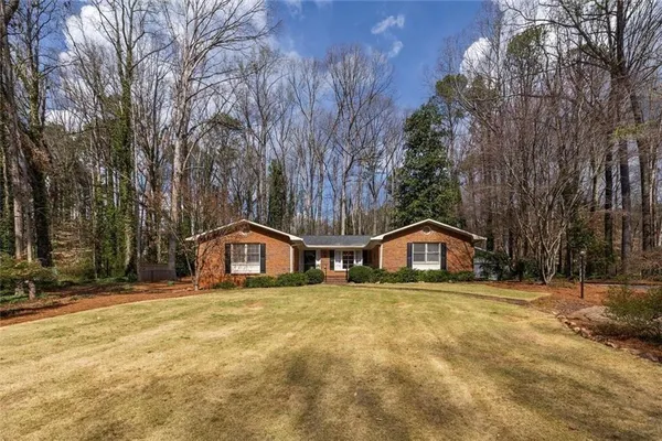 a house that has a tree in front of it