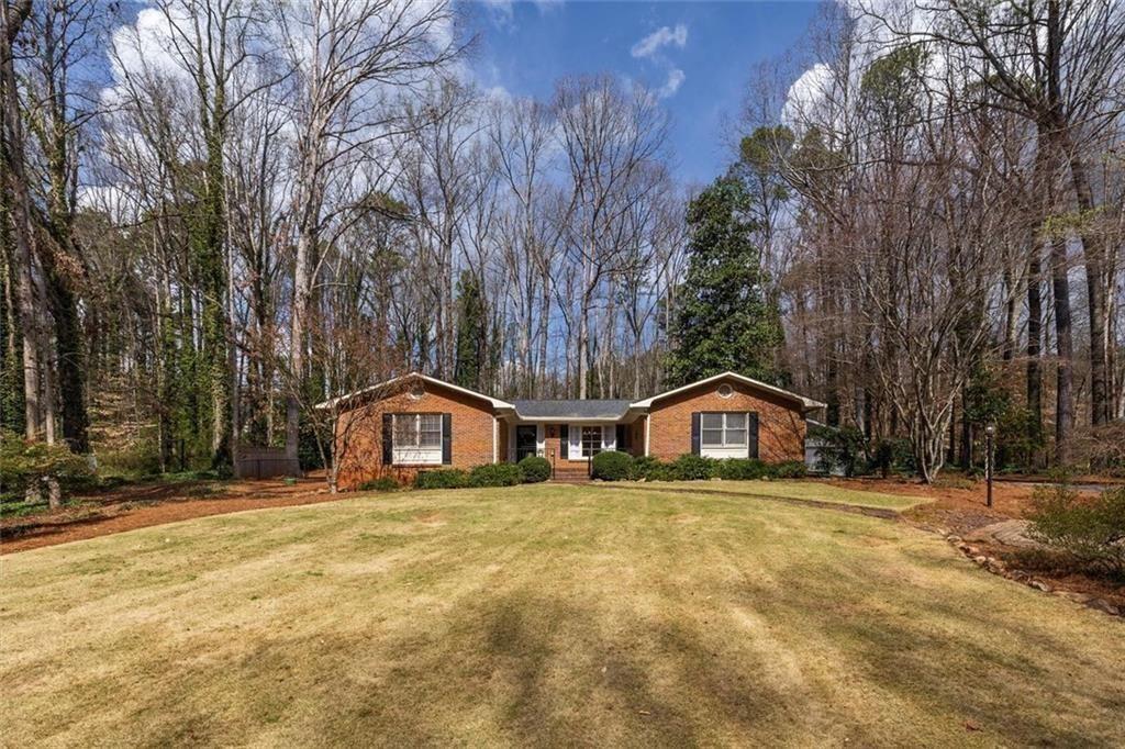 5498 Smoke Rise Drive Smoke Rise, GA 30087 - Photo 42 of 52 a house that has a tree in front of it