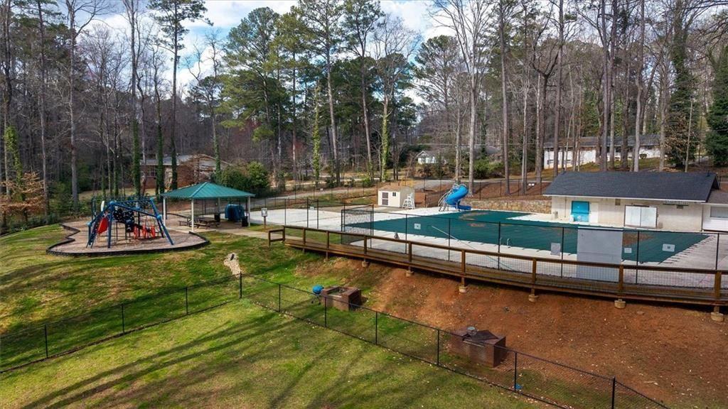5498 Smoke Rise Drive Smoke Rise, GA 30087 - Photo 49 of 52 a view of a swimming pool with chairs