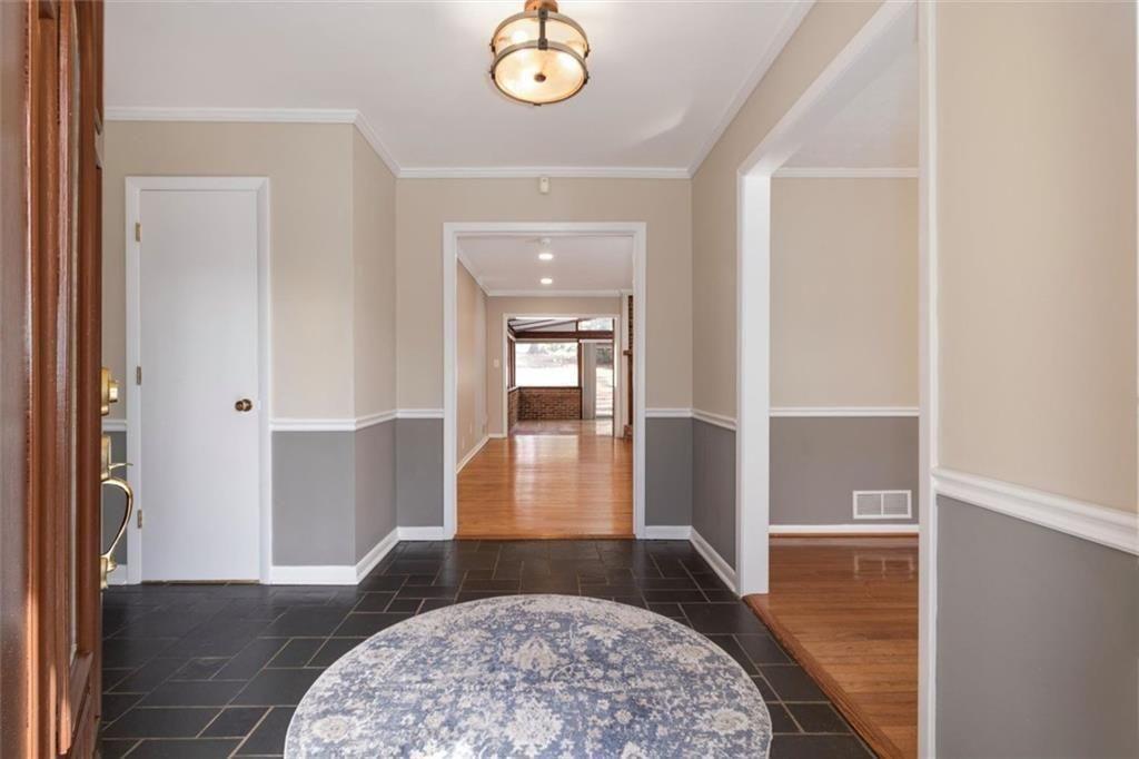 5498 Smoke Rise Drive Smoke Rise, GA 30087 - Photo 6 of 52 a view of a hallway with wooden floor and a rug