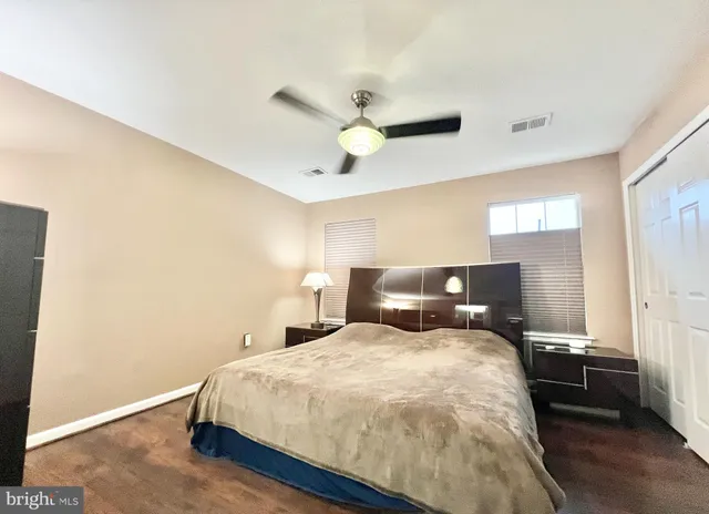 a bed room with a bed and a ceiling fan
