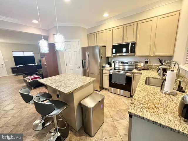a kitchen with a stove a refrigerator and a sink