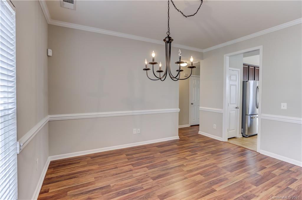 7207 Meyer Road Fort Mill, SC 29715 - Photo 8 of 48 a view of an empty room with wooden floor and chandelier