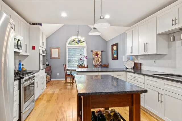 a view of a dining room with furniture and a window