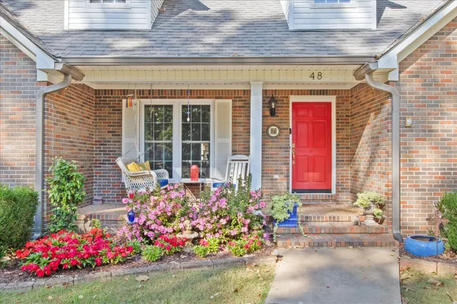a dining room with furniture wooden floor a rug and a chandelier
