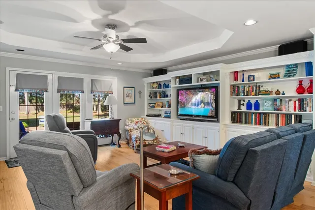 a living room with furniture and a book shelf