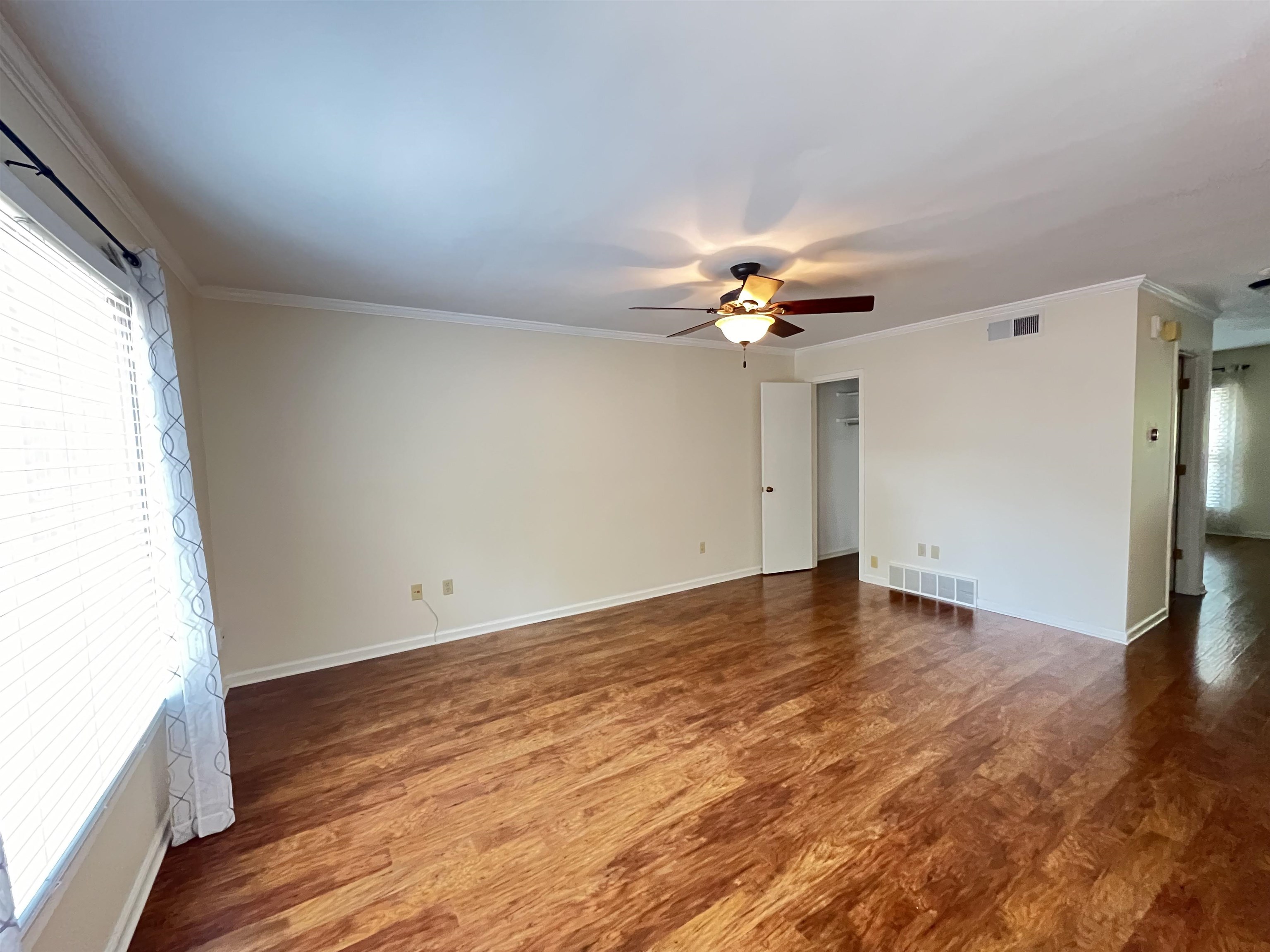 6960 Country Road Germantown, TN 38138 - Photo 11 of 36 an empty room with wooden floor fan and windows