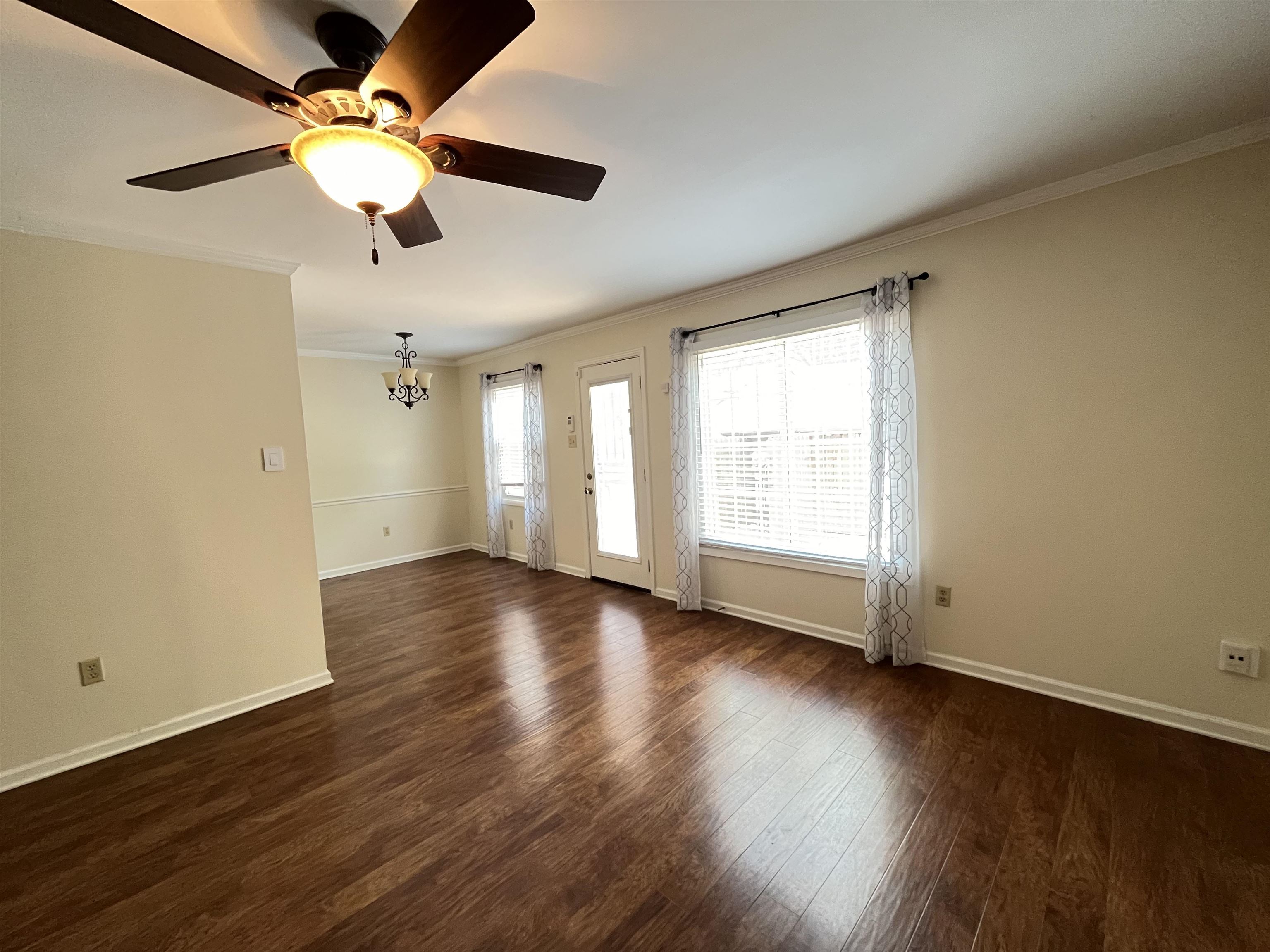 6960 Country Road Germantown, TN 38138 - Photo 12 of 36 a view of an empty room with wooden floor and a window