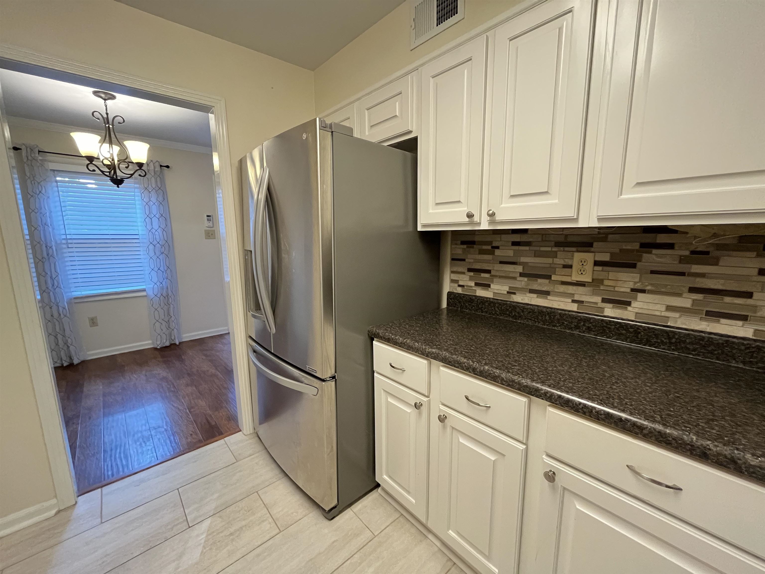 6960 Country Road Germantown, TN 38138 - Photo 15 of 36 a kitchen with granite countertop a refrigerator and a sink