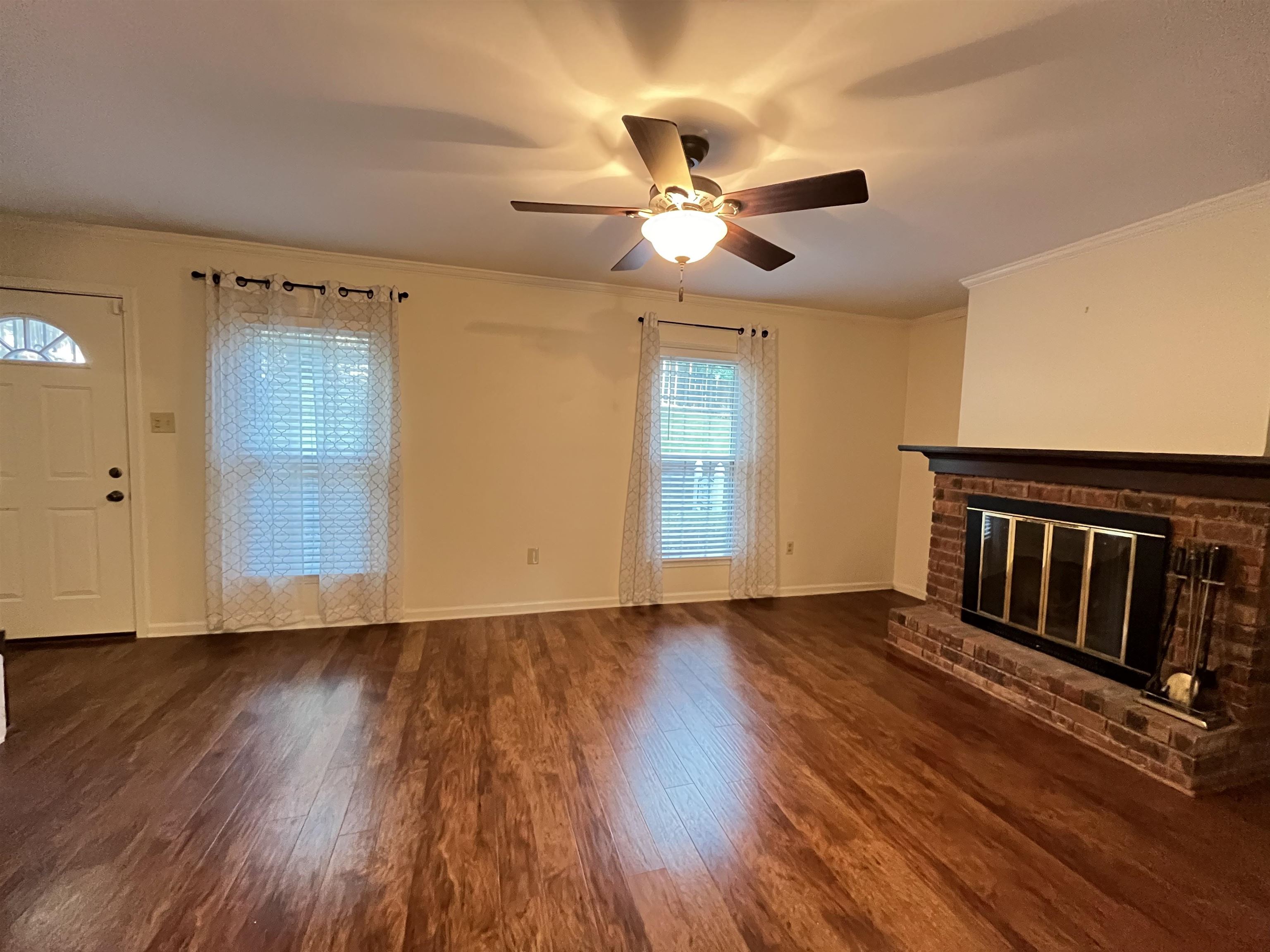 6960 Country Road Germantown, TN 38138 - Photo 17 of 36 a view of an empty room with wooden floor and a window