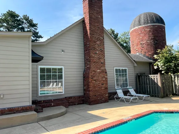a backyard of a house with yard and outdoor seating