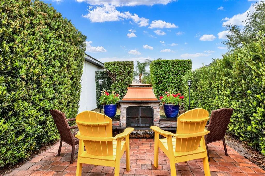 2021 Meadow Rue Court Trinity, FL 34655 - Photo 25 of 41 a patio with table and chairs and potted plants