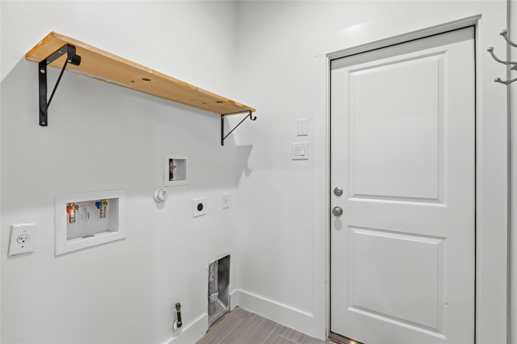 4124 Valley View Road, Unit 4A & 4B Austin, TX 78704 - Photo 28 of 40 A well-appointed utility room features a convenient wall-mounted shelf and durable tile flooring.