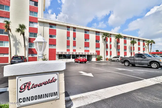 a view of a building with car parked
