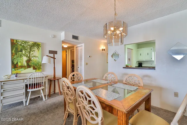 a view of a livingroom and dining room with furniture window and outside view