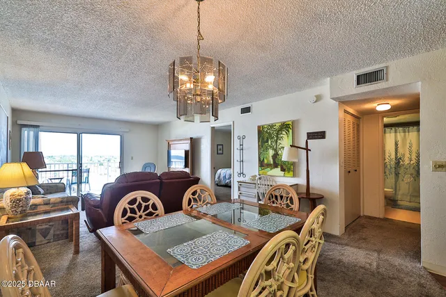 a view of a kitchen with sink and chairs
