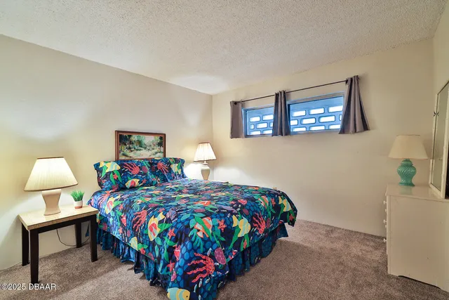 a bedroom with bed and wooden floor