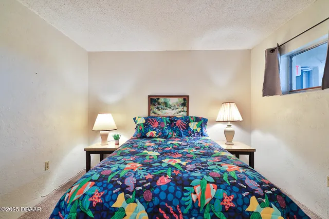 a bedroom with a bed and a dresser in it