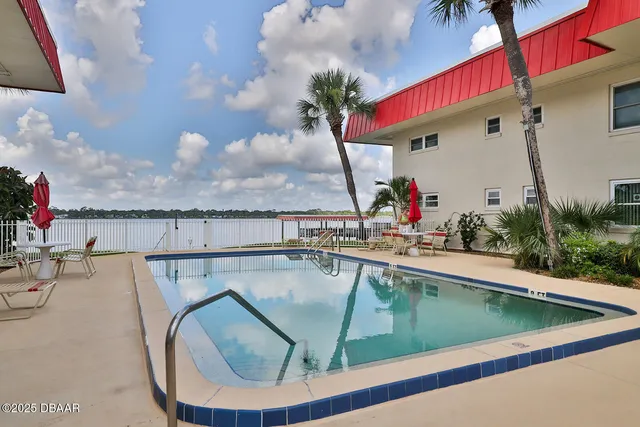 a view of a balcony with yard