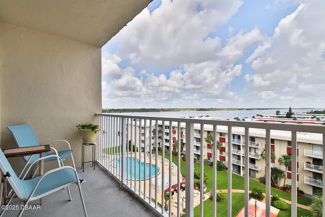 a view of a chairs and table in a balcony