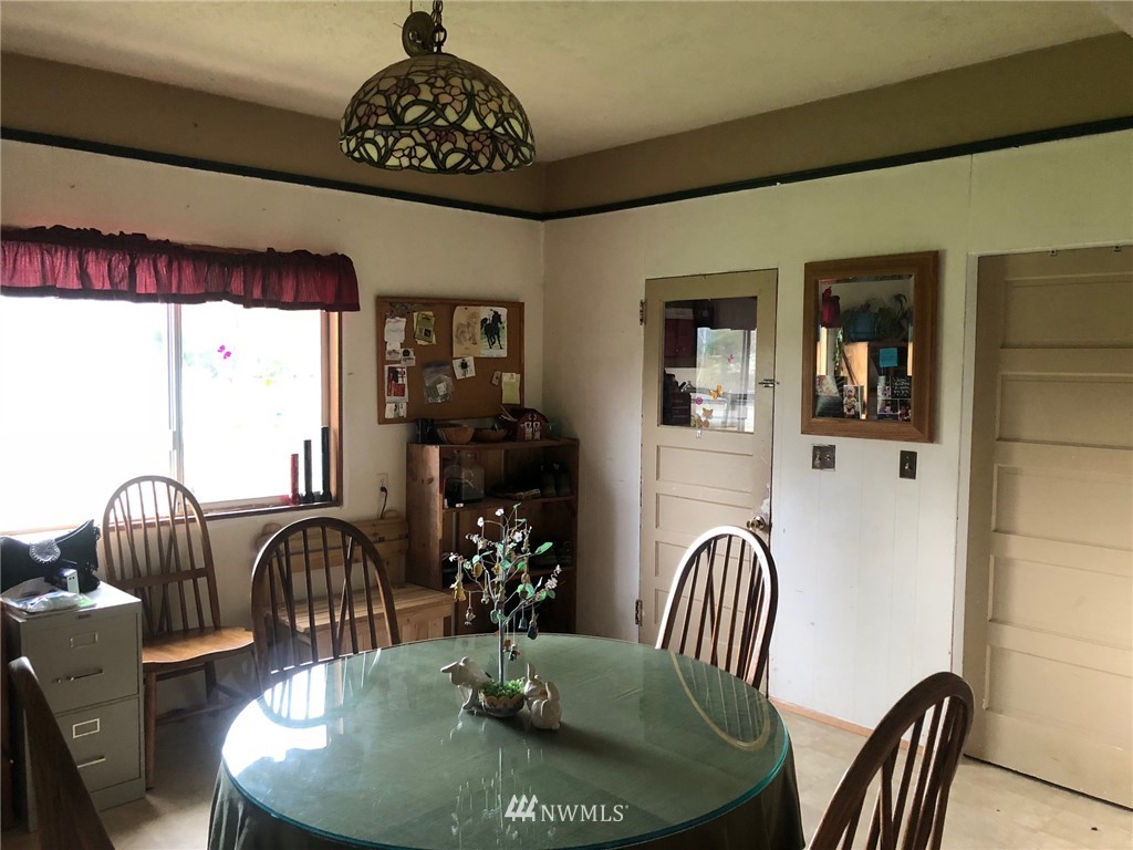 14720 Center Road Quilcene, WA 98376 - Photo 8 of 23 a view of a dining room with furniture wooden floor and chandelier