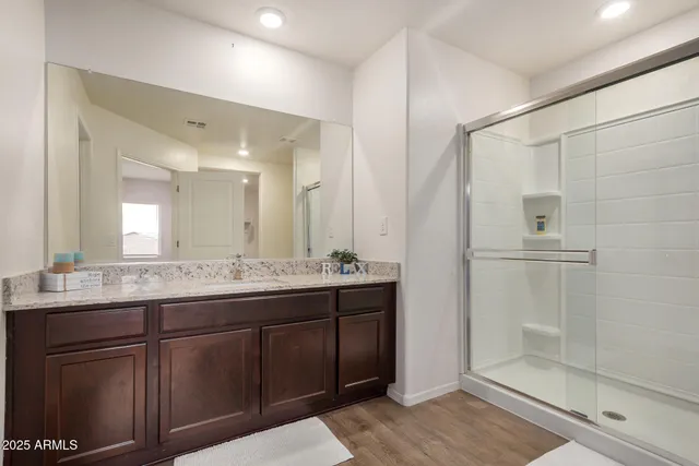 a bathroom with a granite countertop sink and a mirror