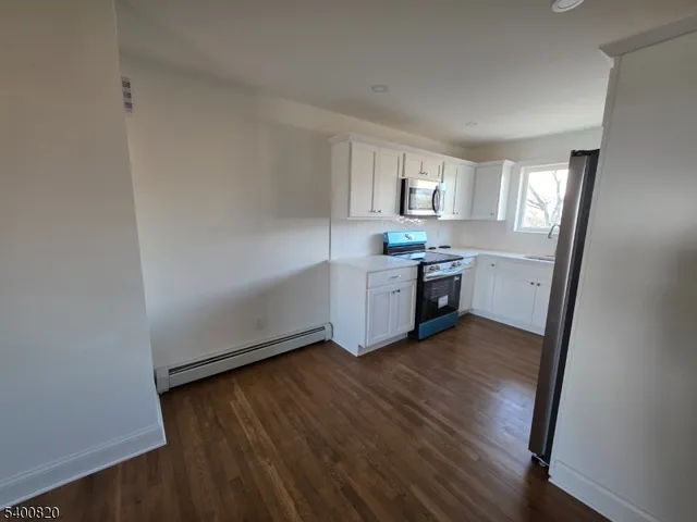 a view of kitchen with sink and wooden floor