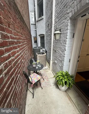a view of a chairs and table in the balcony