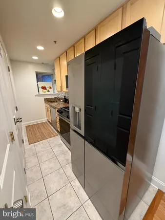a kitchen with stainless steel appliances a refrigerator and a stove top oven